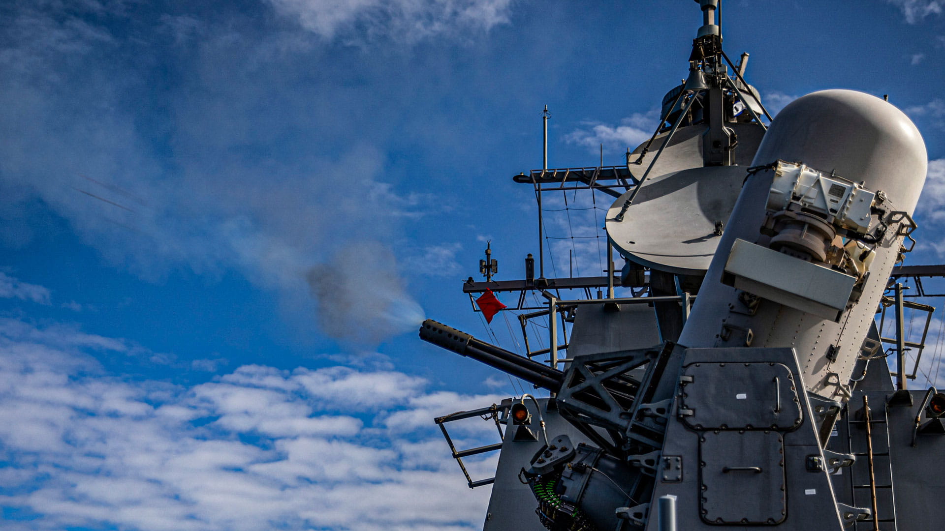 The Arleigh Burke-class guided-missile destroyer USS Rafael Peralta (DDG 115) fires a Phalanx Close-In Weapons System (CIWS) during a live fire exercise (U.S. Navy photo by Mass Communication Specialist 2nd Class Colby A. Mothershead)