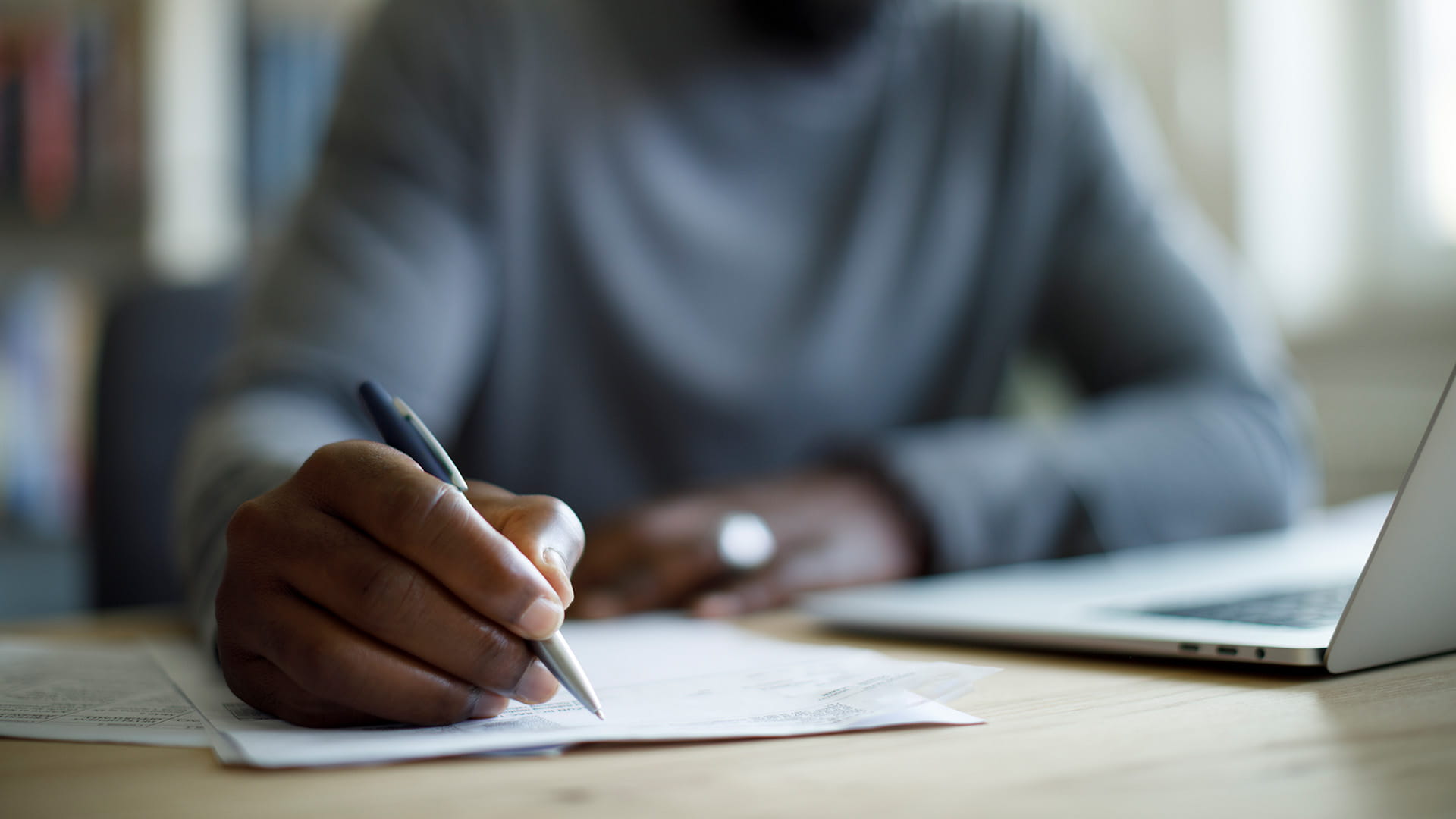 Person taking notes at a desk