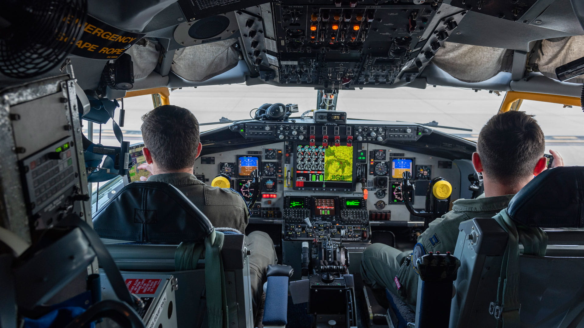 Pilots on the flight deck of a military aircraft