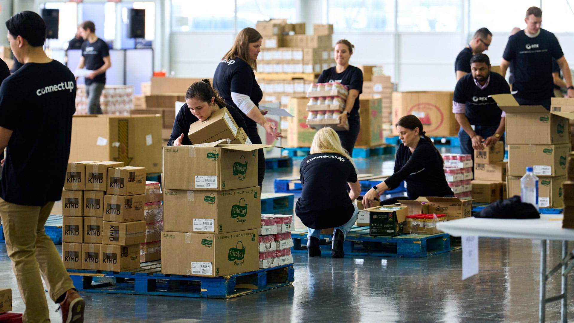 Men and women pack boxes