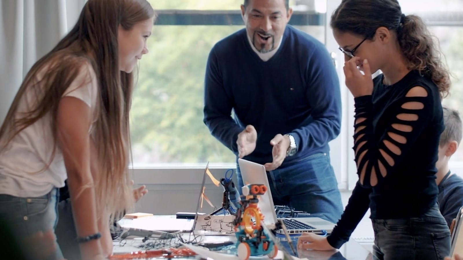 a group of people standing around a table