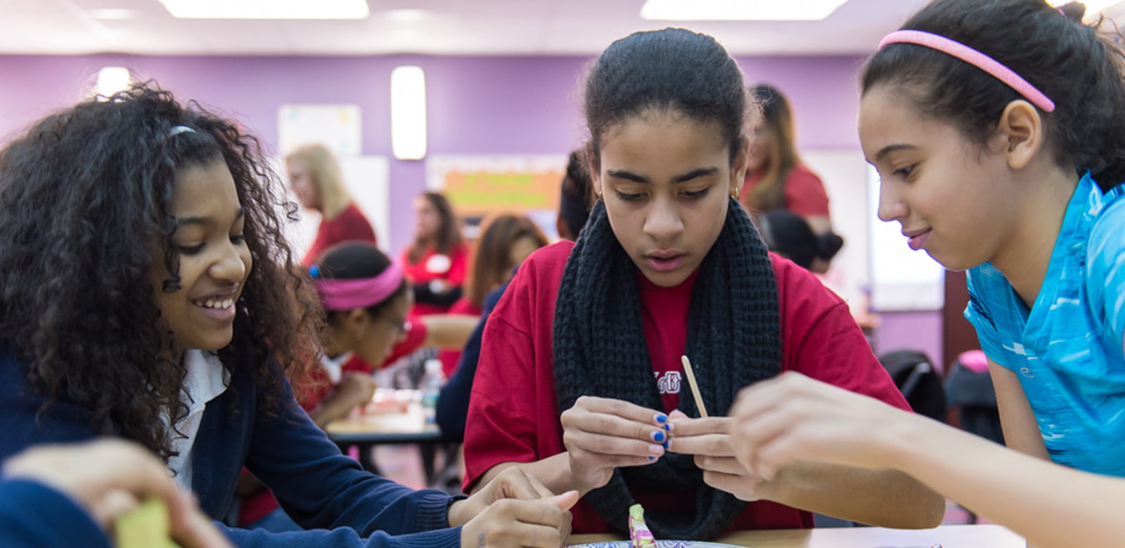 Three girls working together on a science experiment