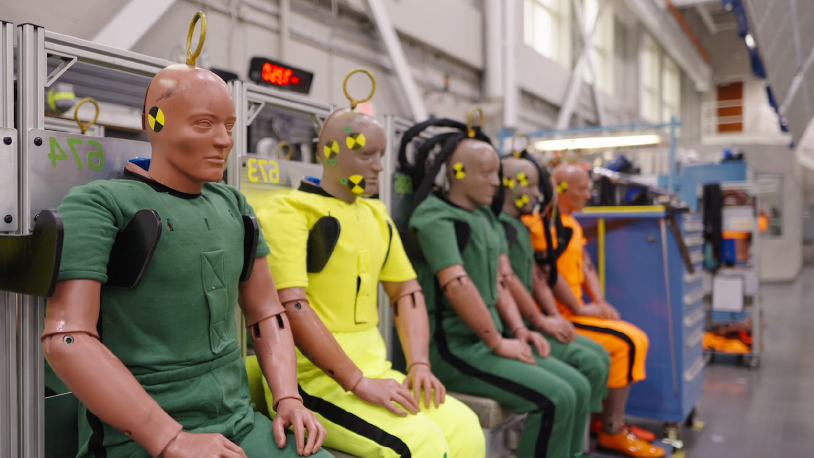 Five safety test dummies strapped into seats