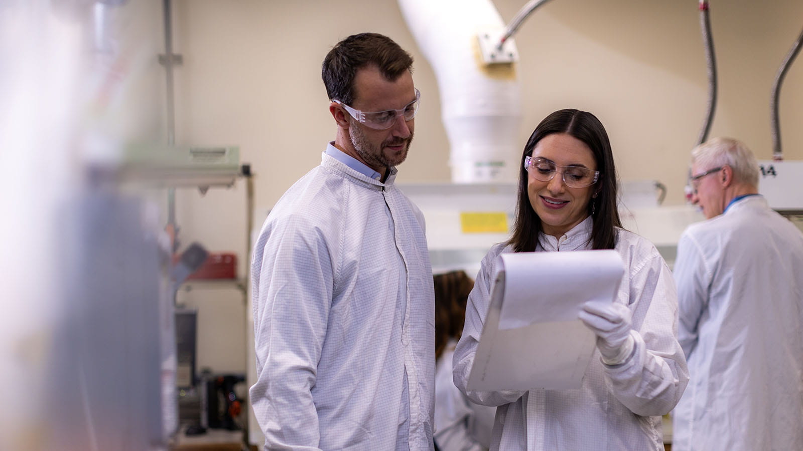Man and woman engineer reviewing plans