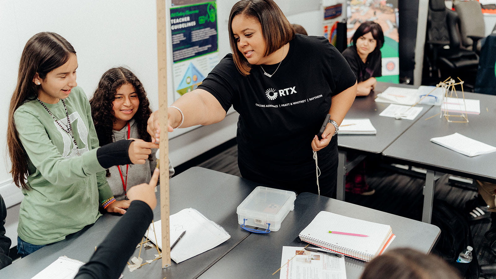 Women volunteering with two students