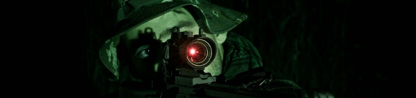 man wearing a helmet looking through an infra red camera