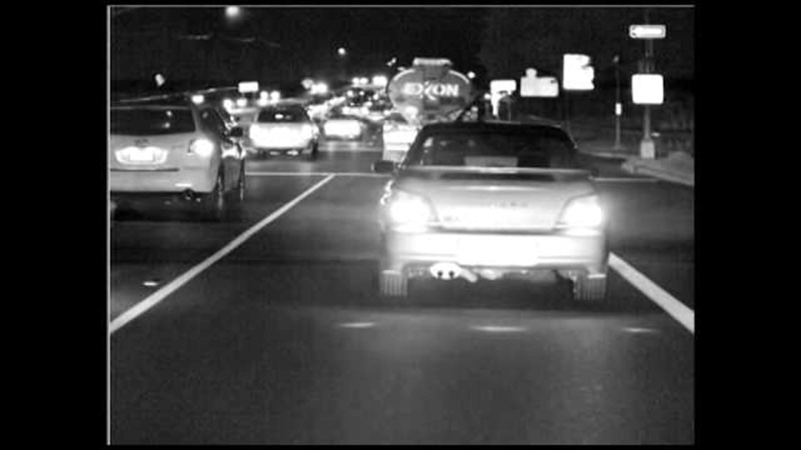 vision enhanced road with car ahead at night