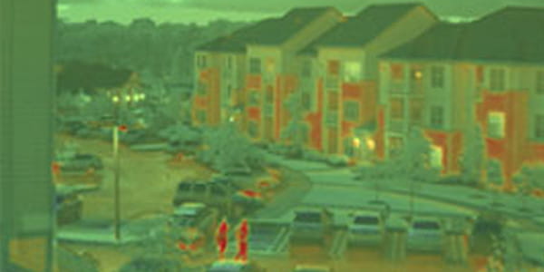 hinted swir night view poepl in hotel parking lot