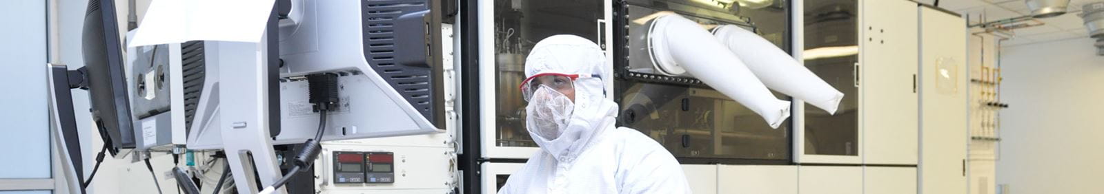 A person wearing a hazmat suit in a lab