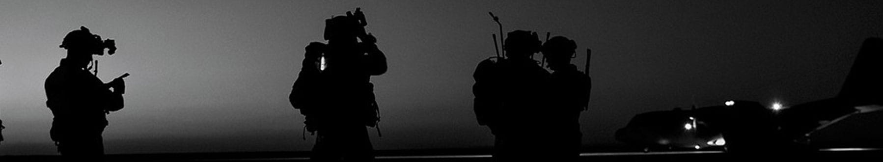 A group of soldiers with a Lockheed Martin C-130 in the background