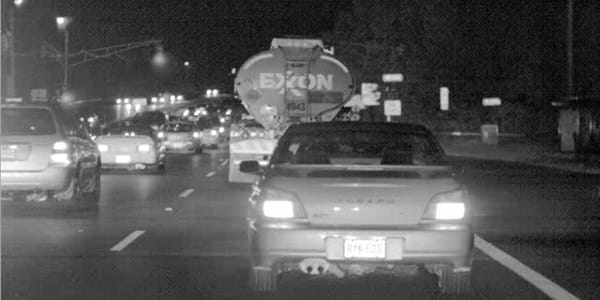 vision enhanced night road with car ahead