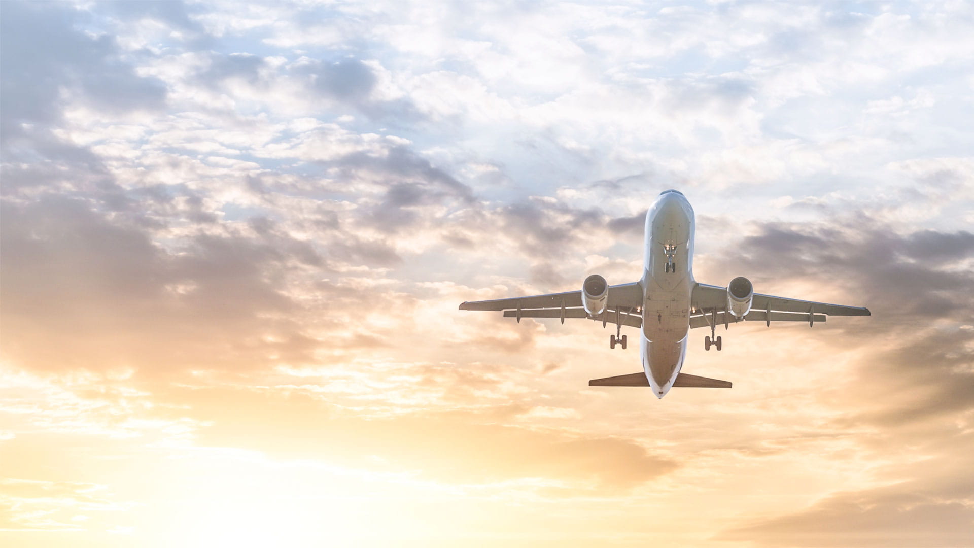 An aircraft takes off during sunrise