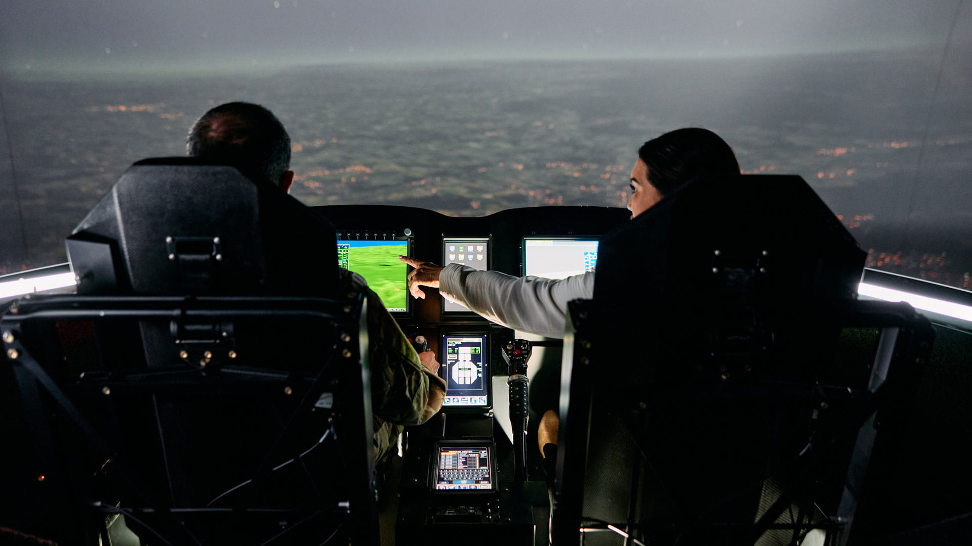 People sitting in an aircraft cockpit simulator