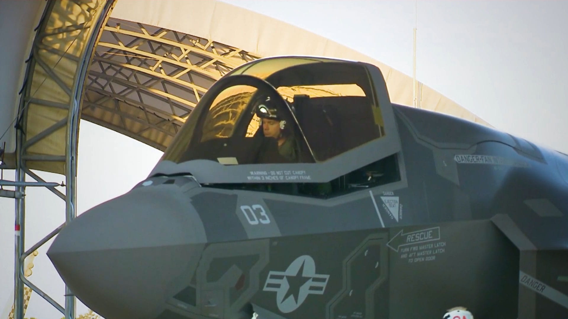 Pilot in fighter jet as canopy closes