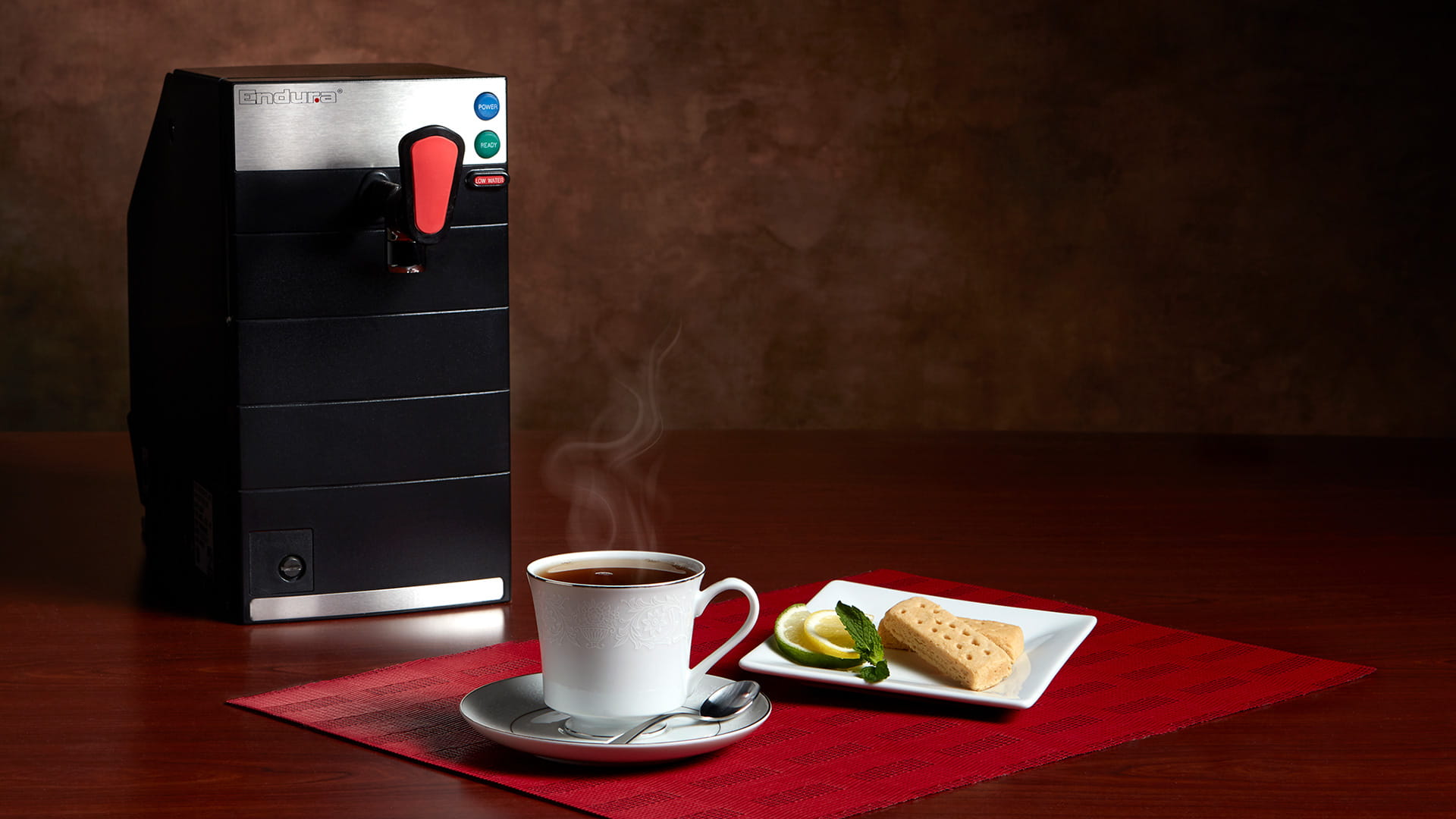 Endura water heater pictured with a cup of coffee