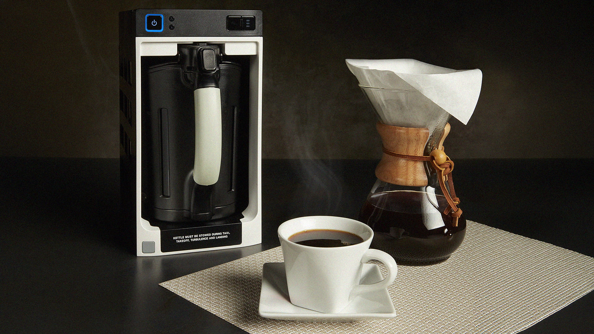 A coffee maker, carafe, and coffee cup