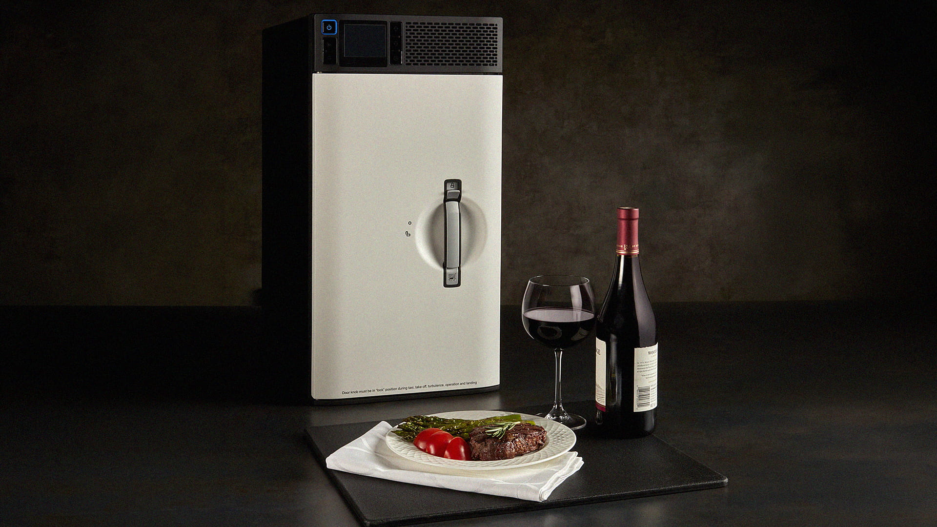 A convection oven, a plate of food, a bottle of wine, and a wine glass