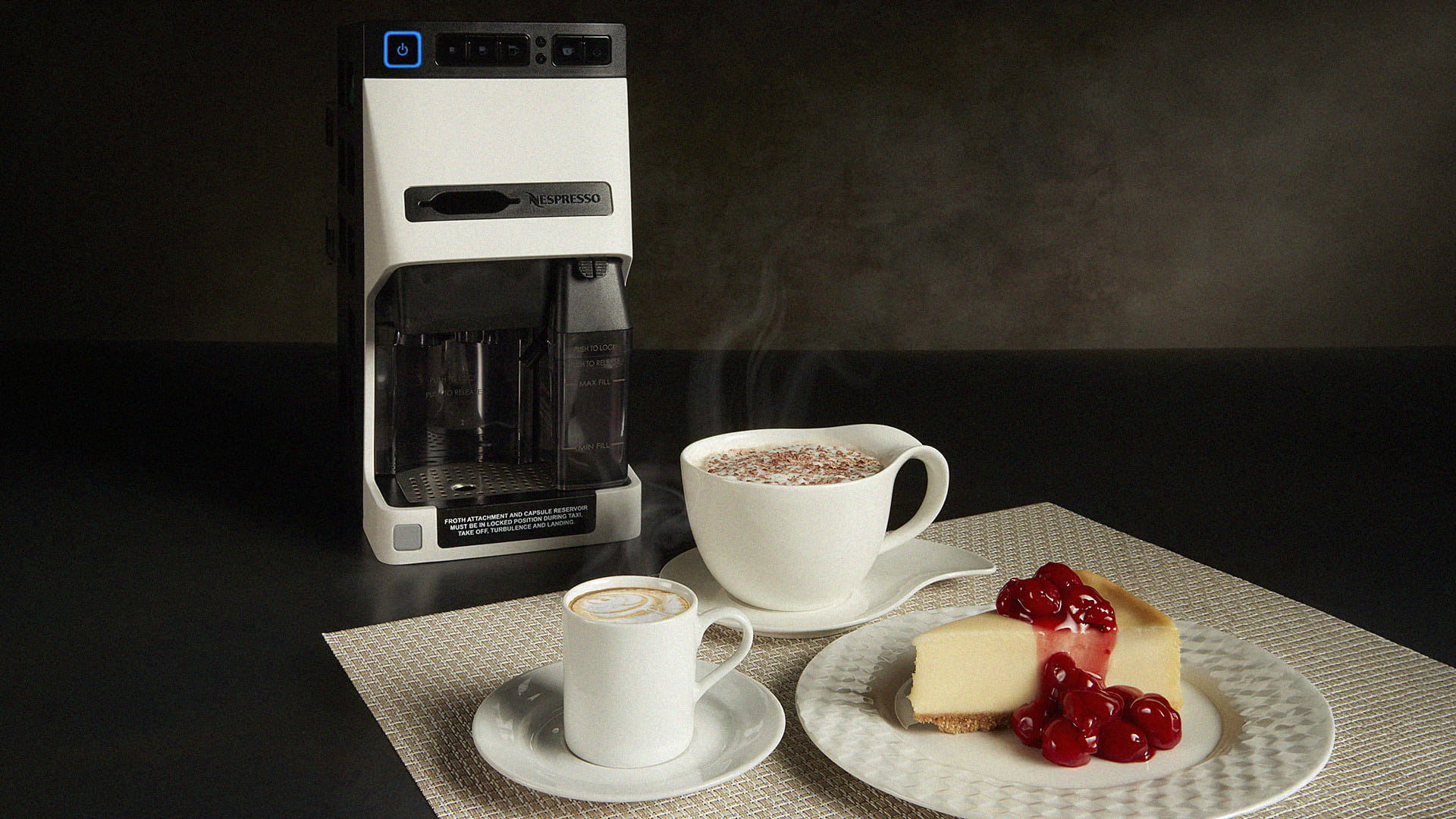 A nespresso machine, two beverage cups, and a slice of cheesecake on a dessert plate