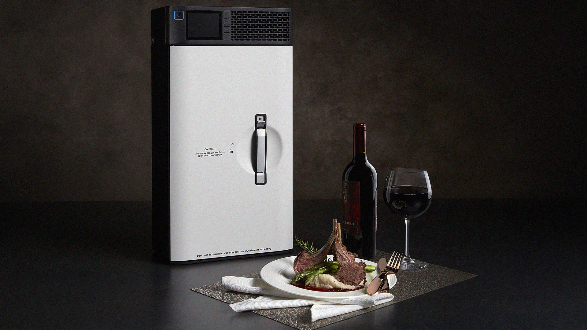 A convection oven, a plate of food, a bottle of wine and a wine glass