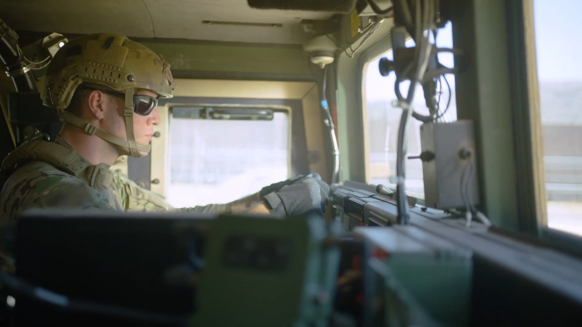 A soldier driving a military vehicle