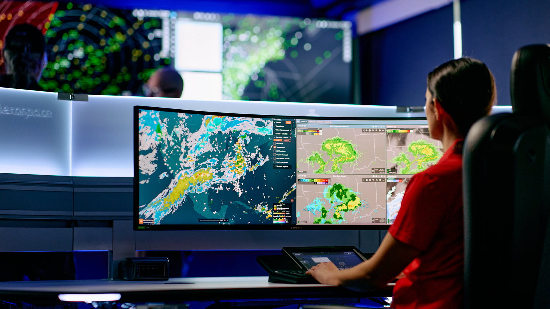A woman operates a MARS common automation workstation for aviation professionals