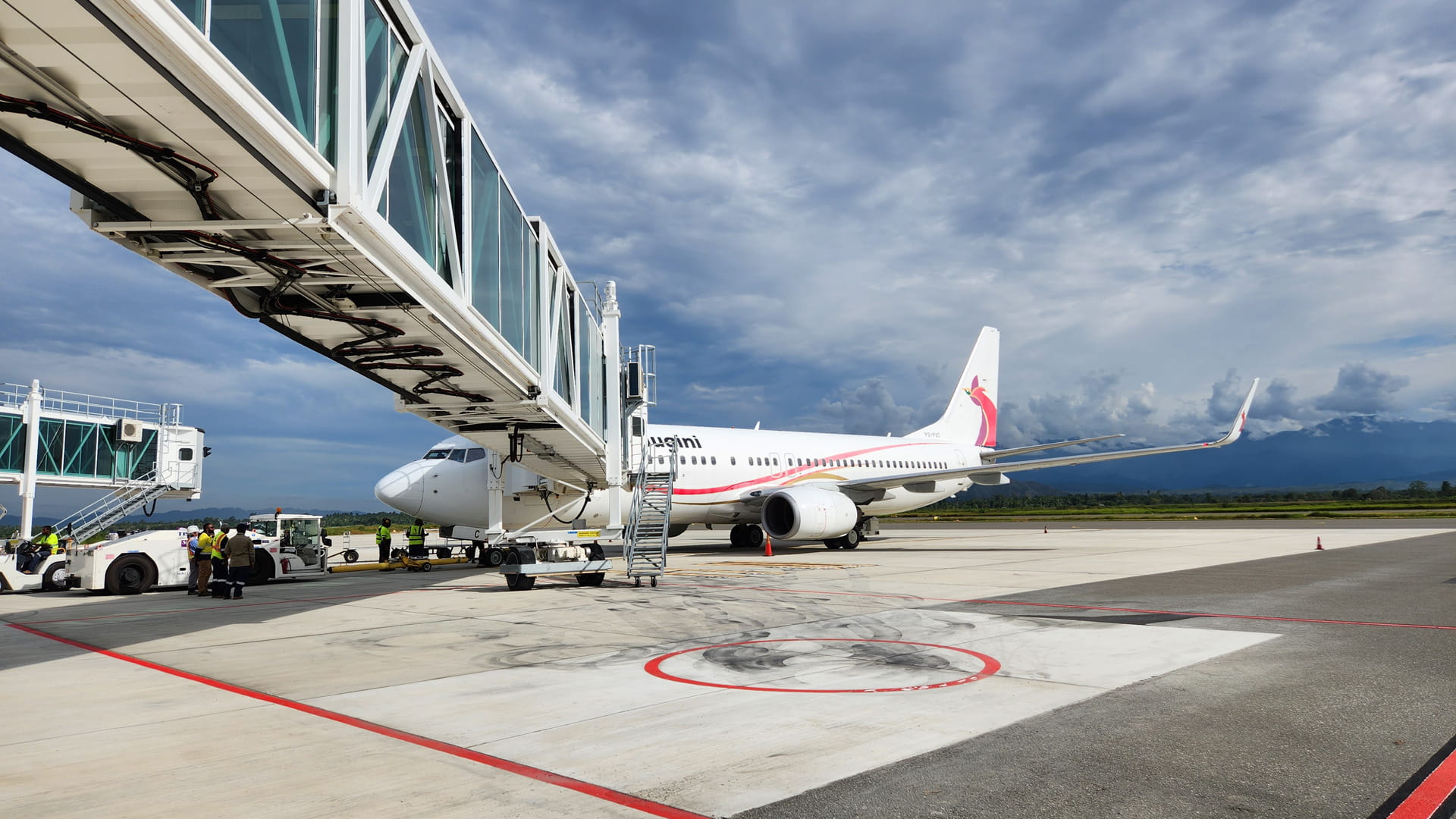 An airplane docked at an aerobridge