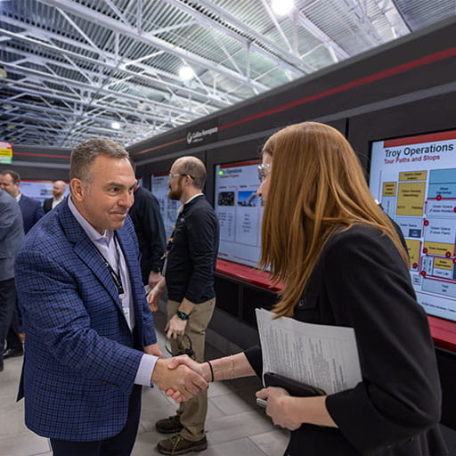 Collins Aerospace President Troy Brunk shakes hands with an employee during a visit to the company's wheel and brake facility in Troy, Ohio.