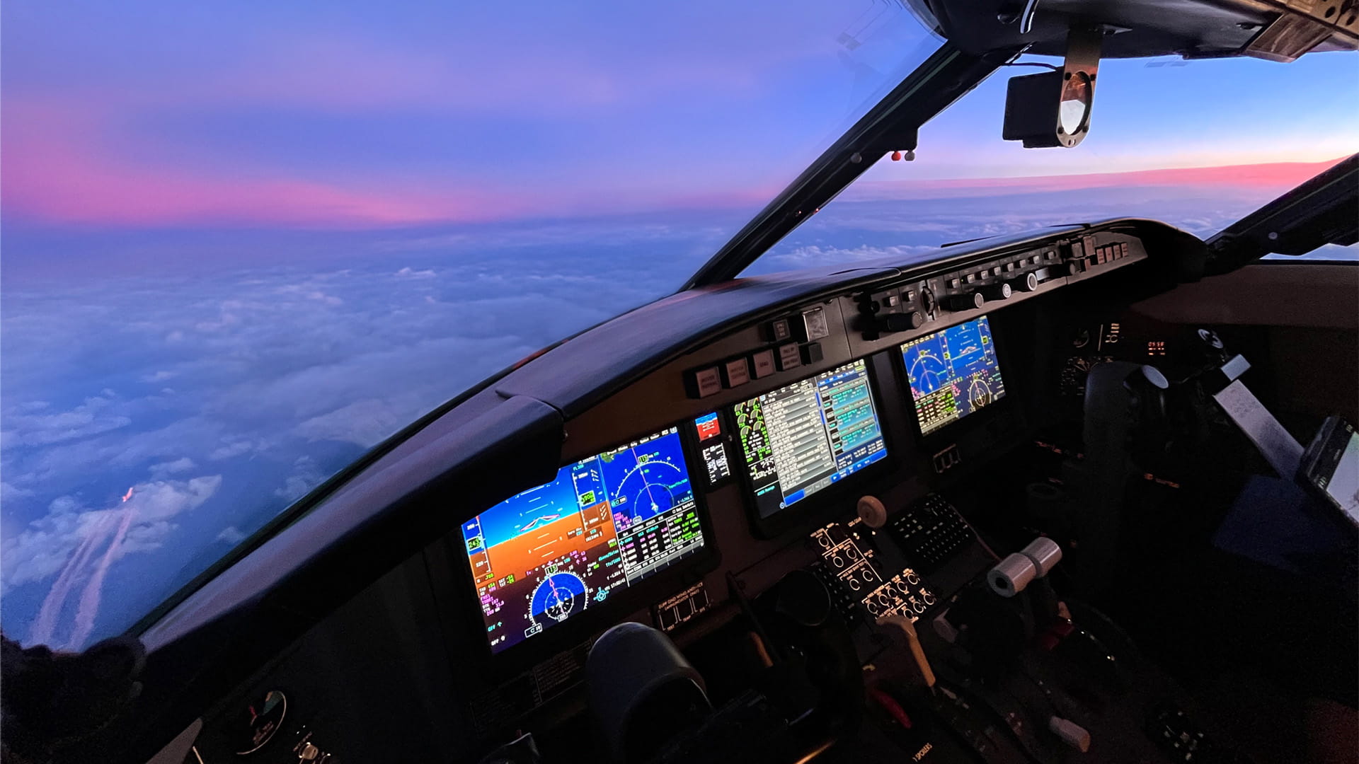Aircraft cockpit view looking out at cloud-cover below