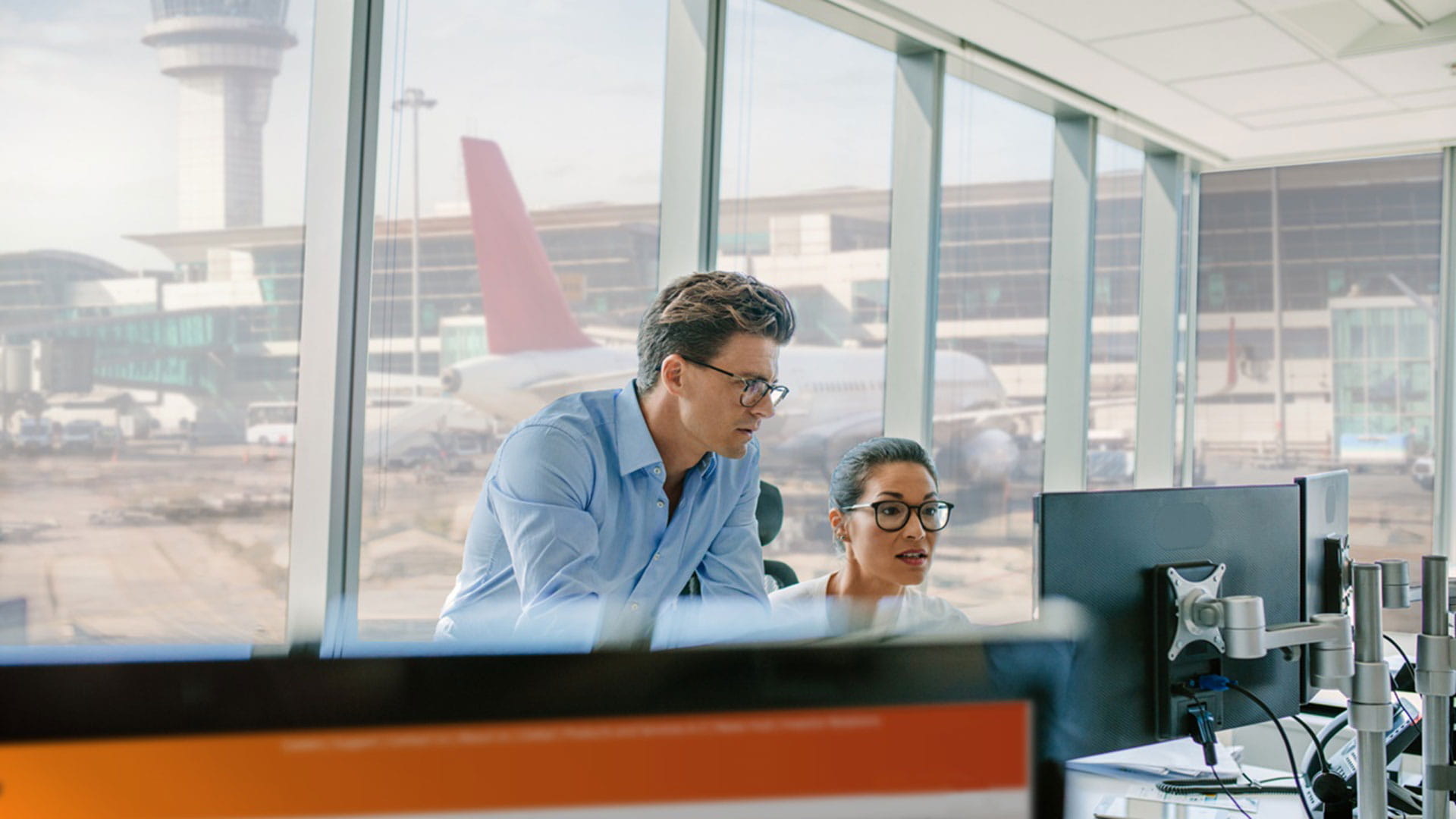 Employees looking at PC monitor