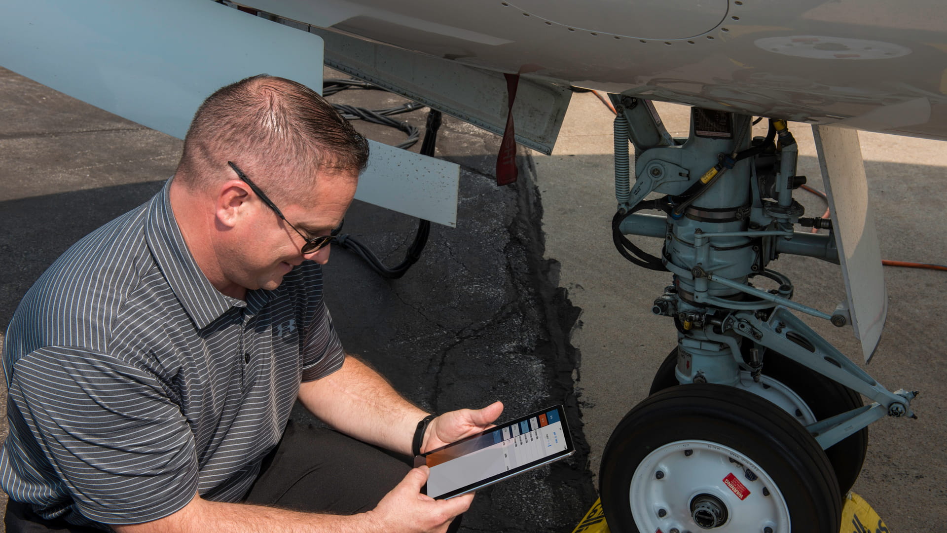 Engineer next to plane wheel