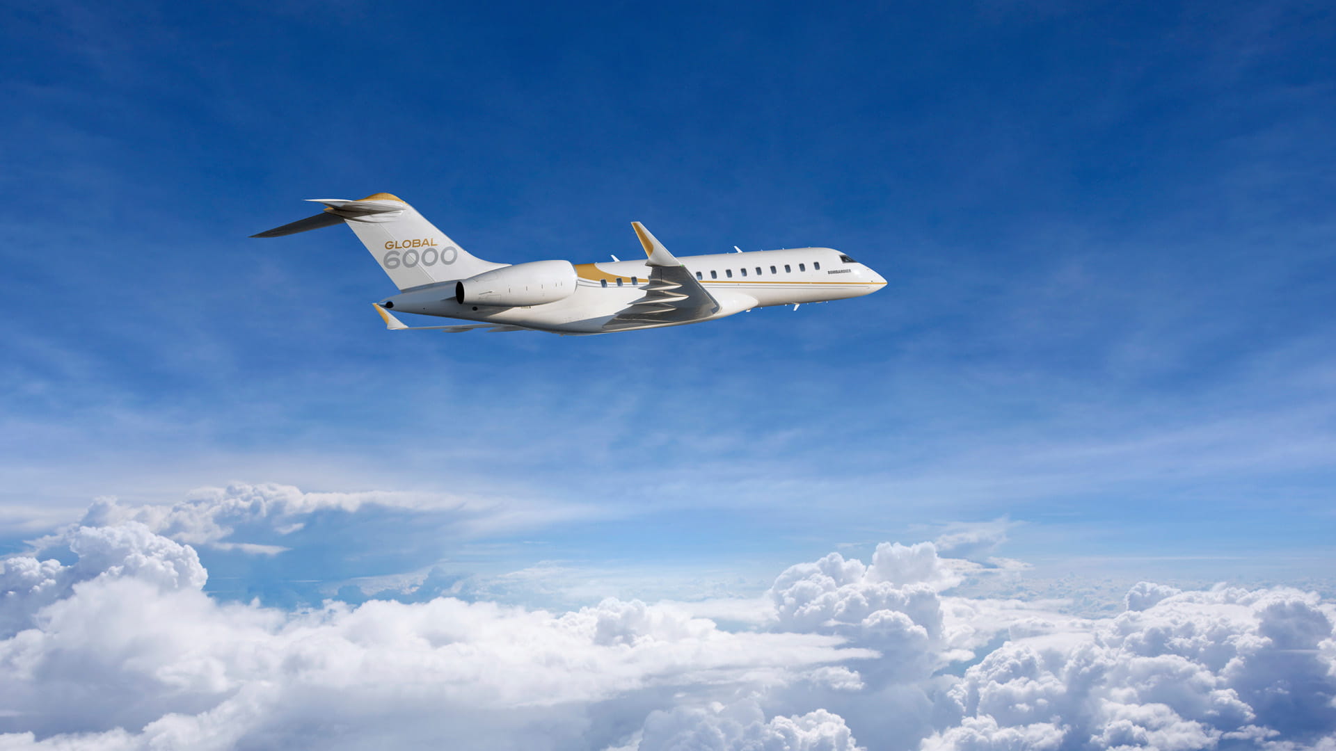 Side view photo of Global 6000 aircraft in flight above the clouds