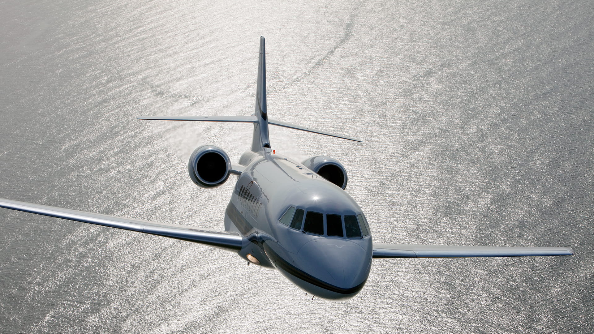 Private jet over body of water