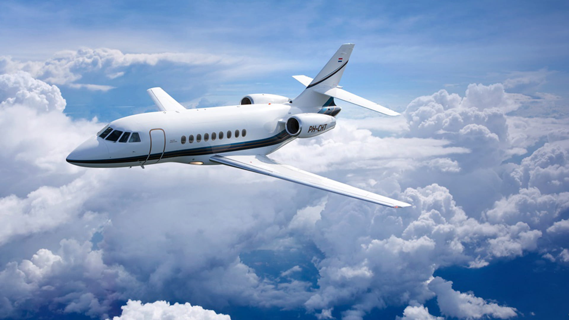 Private jet above clouds