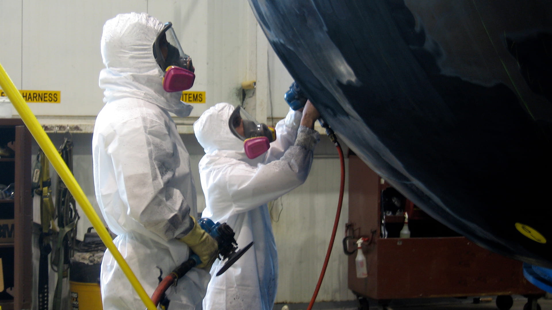 Field service engineers performing maintenance on a sonar dome