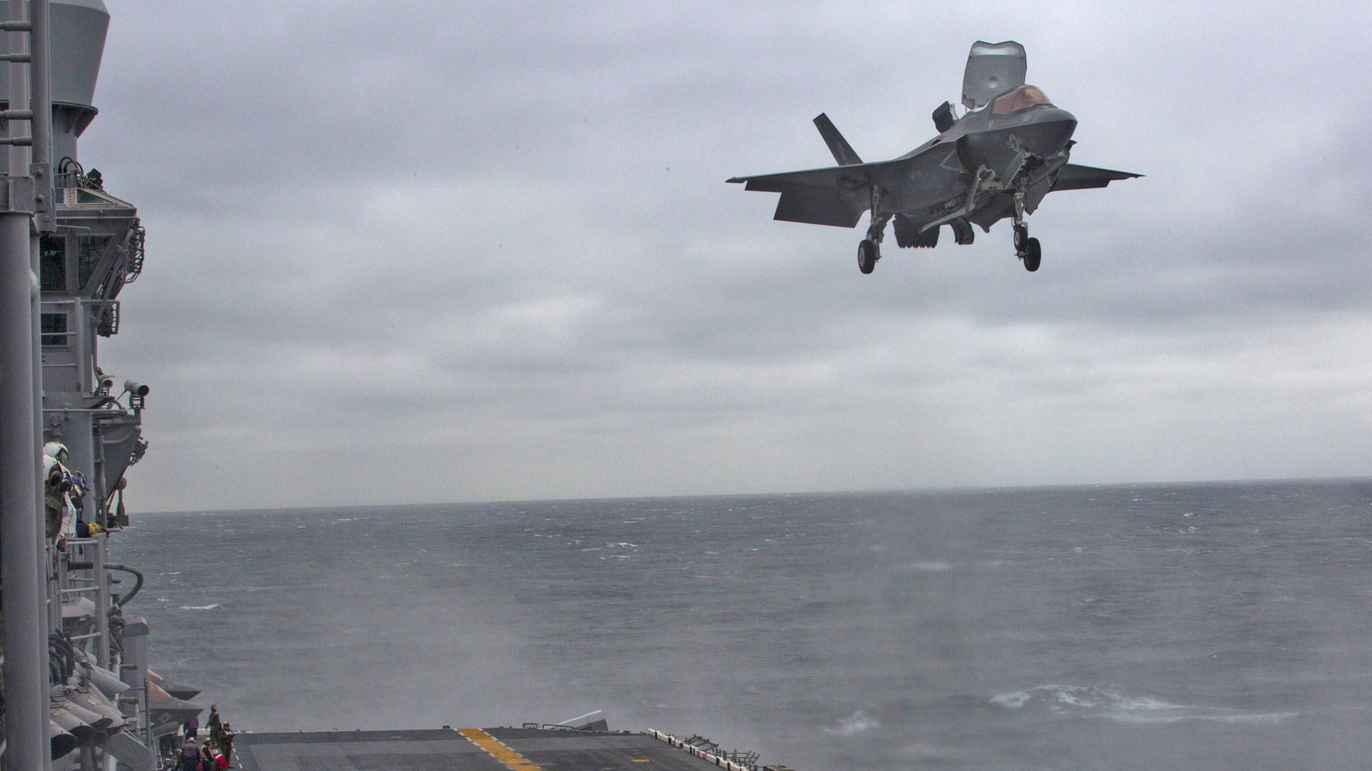 An F-35 flight approach (prior to trapping) during sunset. Photo by Jeffrey M Sherman