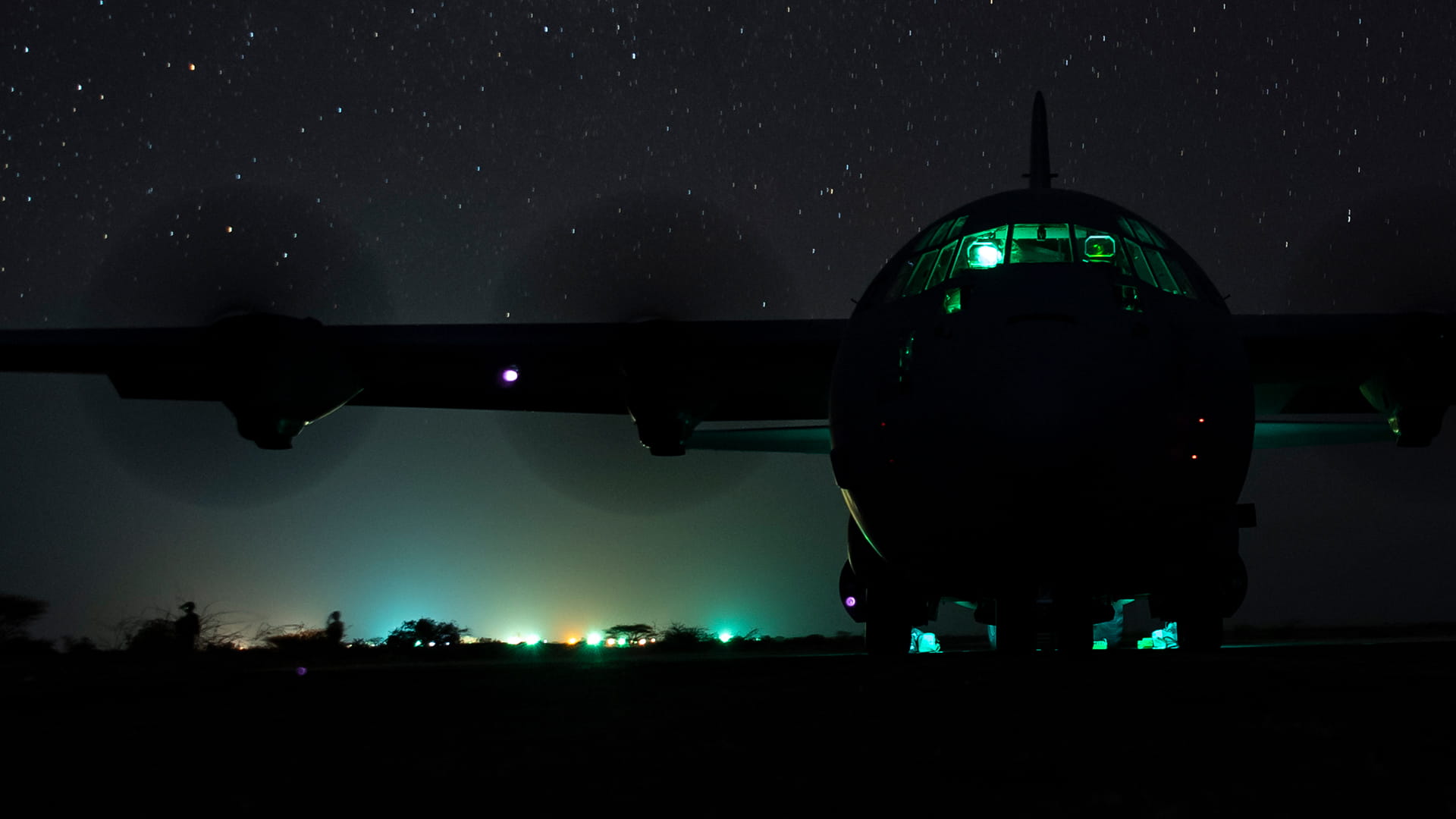 Military C130 flying in the night