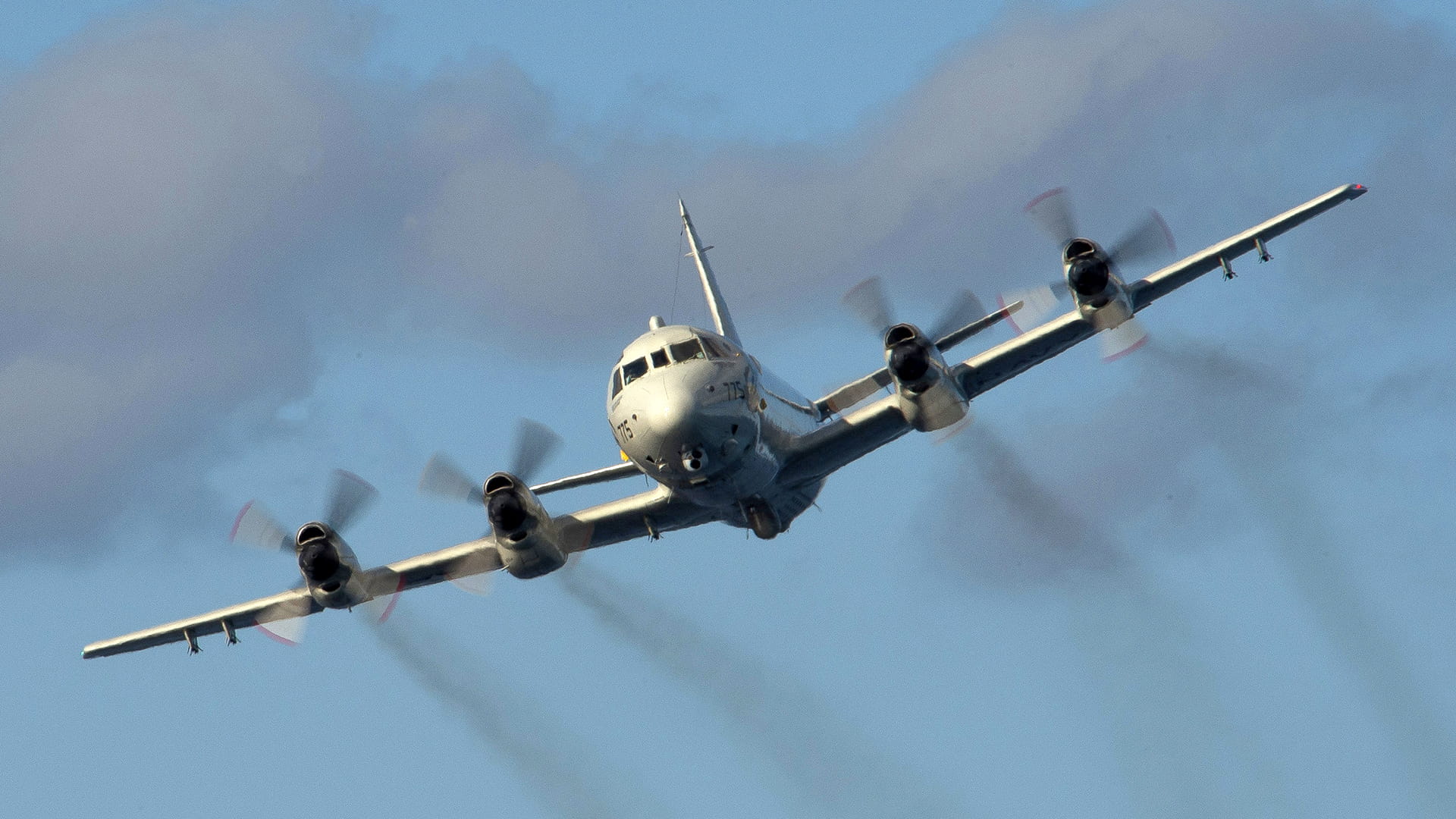 Military plane in flight with smoke stream