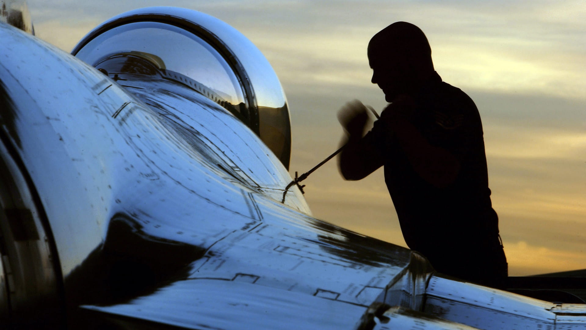A man servicing an airplane