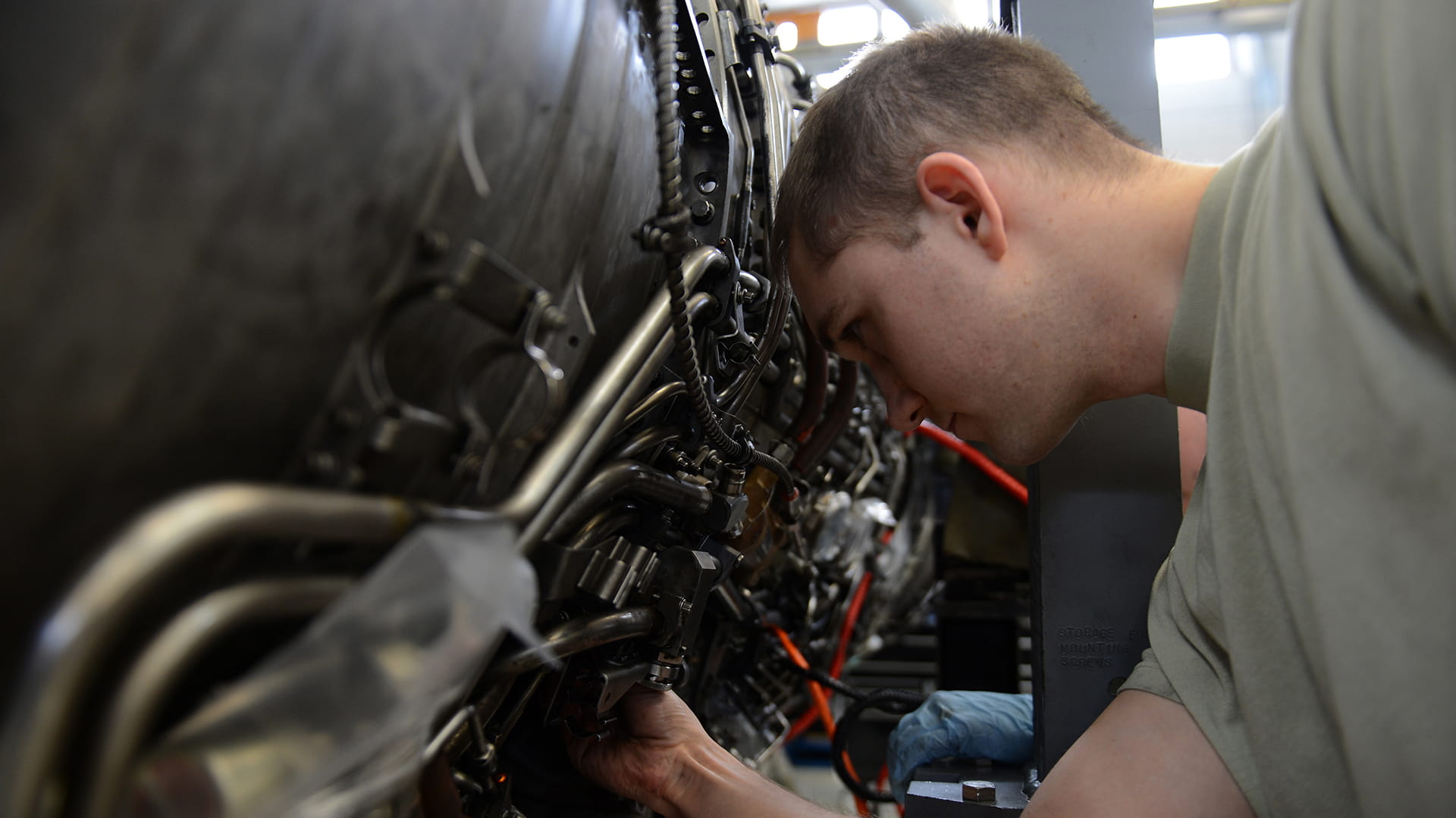 Military machinist working on avionics parts and repairs