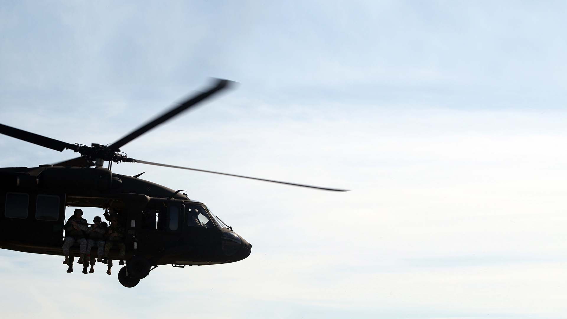 Soldiers sitting in a Sikorsky MH-60 Black Hawk