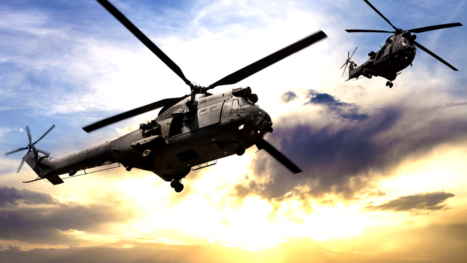 Two military helicopters in flight