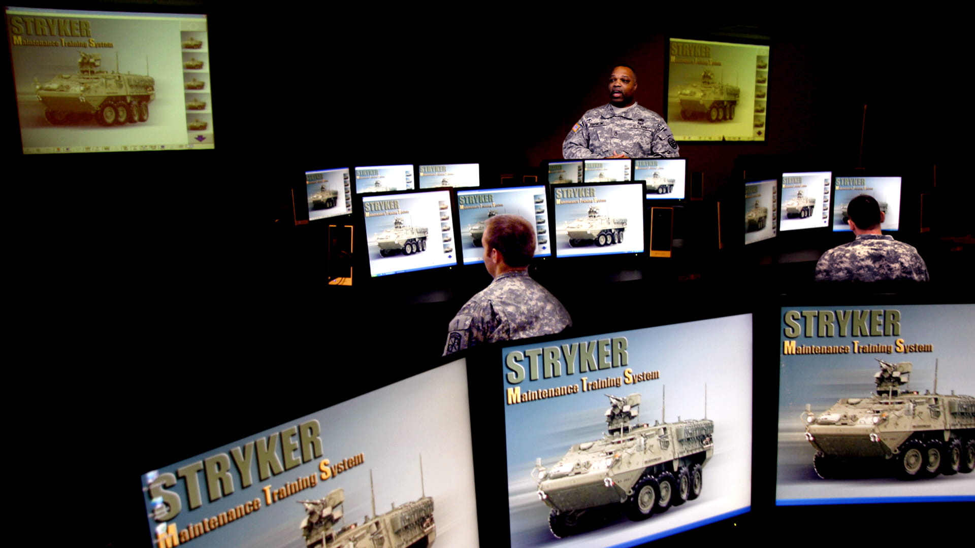 Photo of maintenance training classroom with views of monitors featuring STRYKER maintenance training system (MTS)
