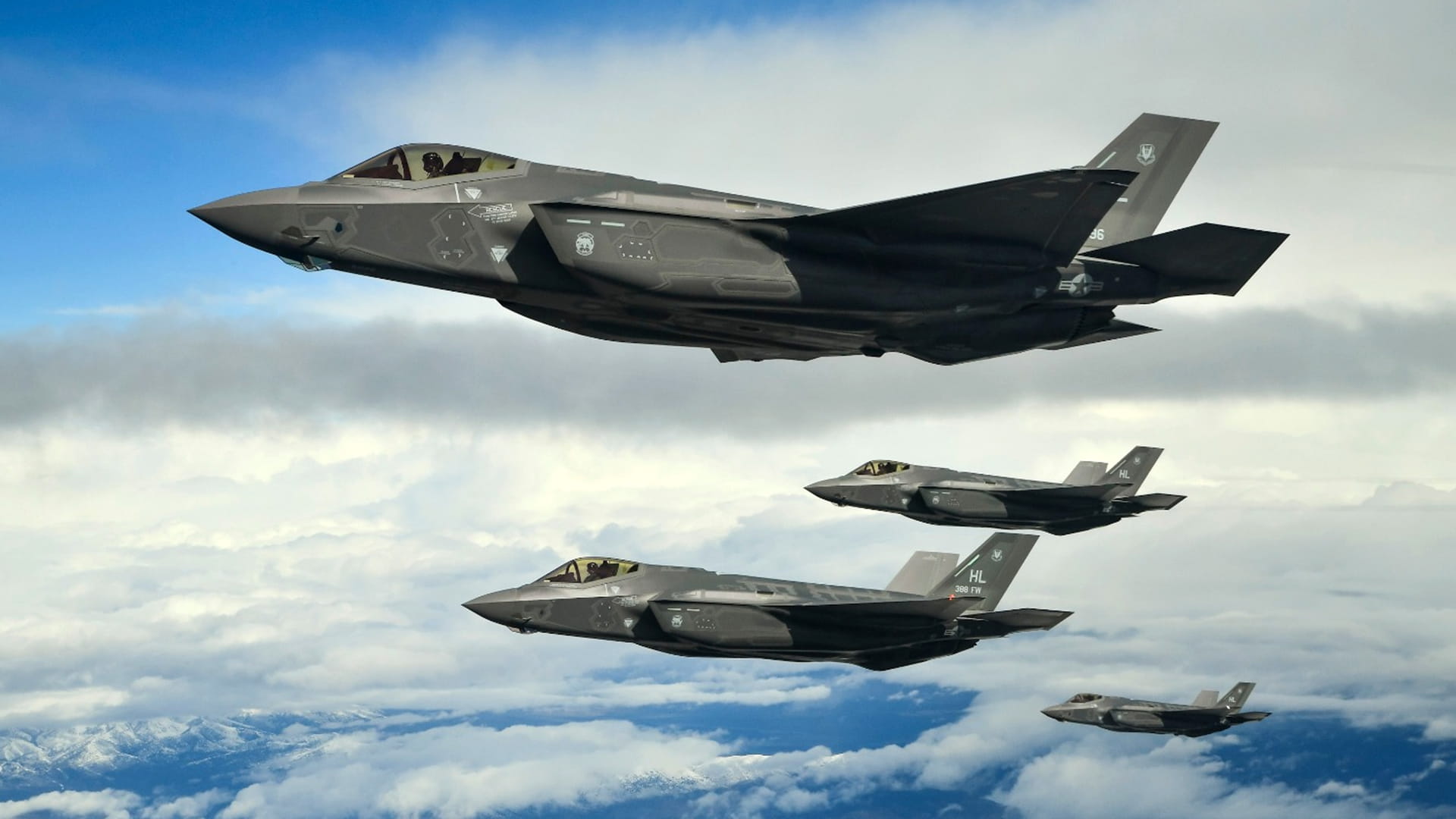 Four warfighting jets flying in the clouds