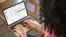 A person sitting and doing work on a laptop computer