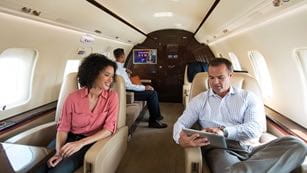 A few people sitting comfortably in an airplane cabin
