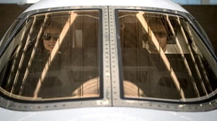 two pilots sitting in the cockpit of an airplane