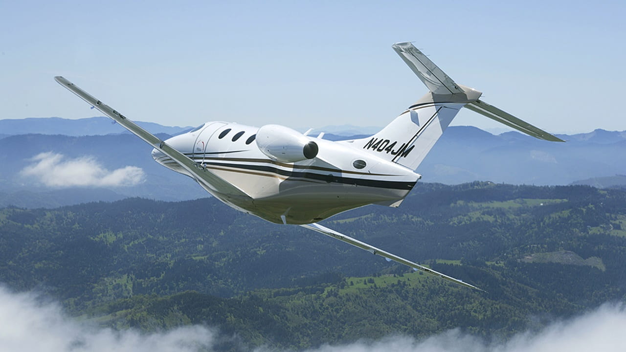 business jet flying through clouds