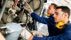 two technicians working in airport hangar