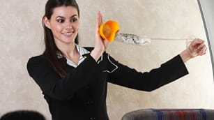 flight attendant demonstrating how to use oxygen mask