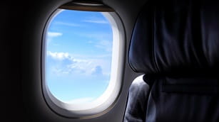 airplane window and white clouds